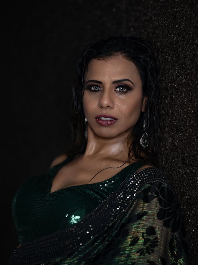 Natasha in a green shimmer saree, studio portrait